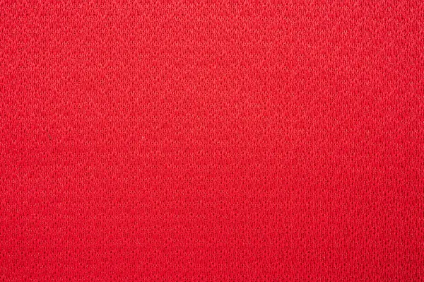 Kırmızı polyester kumaş dokusu ve arka planının tam kare görüntüsü. Bu kumaş dünyanın en popüler tekstil ürünlerinden biridir ve binlerce farklı tüketici ve endüstriyel uygulamalarda kullanılır..