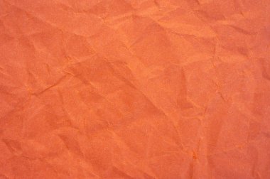 Buruşmuş turuncu kağıt yaprak dokusu ve arka planının tam kare görüntüsü.