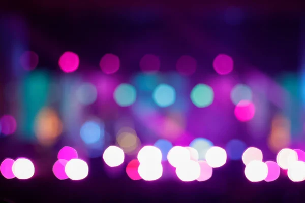 Defocus blurred abstract purple viva magenta bokeh background. Festive spotted glitter background. Blurry music performance in rock band concert. Out of focus.