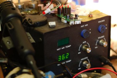 Feshedici lehim istasyonu. İşyerindeki demir dijital istasyon lehimleniyor. LED ekranlı lehim istasyonu, ısıtma kontrol regülatörü, sıcak hava tabancası ve lehimleme demiri. Odaklanamıyorum.