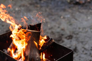 Defocus fire flame firewood fireplace wood. Bright flames burning wood on black background. Camp fire in the night. Cold weather in Europe. Out of focus.