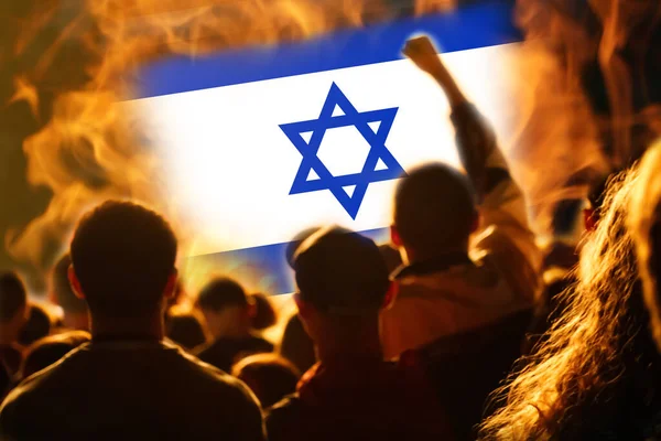 Protests Israel Tel Aviv. Israel flag. Protest in Israel 2023. Rise hand. Defense minister. Fire. Out of focus.