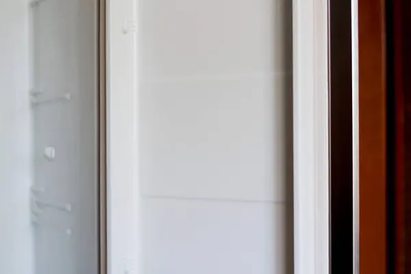 open white refrigerator door, showcasing modern appliances and potential repair services, perfect for inclusion in home improvement websites or appliance repair company advertisements.