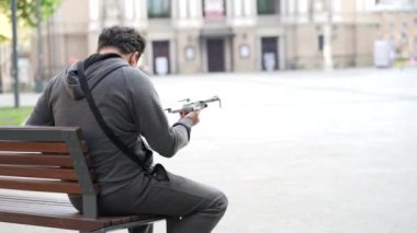 man launching drone quadcopter at urban background. cityscape. modern device. a man controls a drone on the streets of lviv.