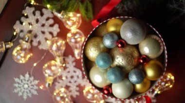 Old box with Christmas toys - golden deer, colorful balls, and tinsel. Old box with Christmas toys - golden deer, colorful balls, and tinsel