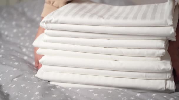 Close Hands Placing Stack Fresh White Linens Top Sheet Room — Stockvideo