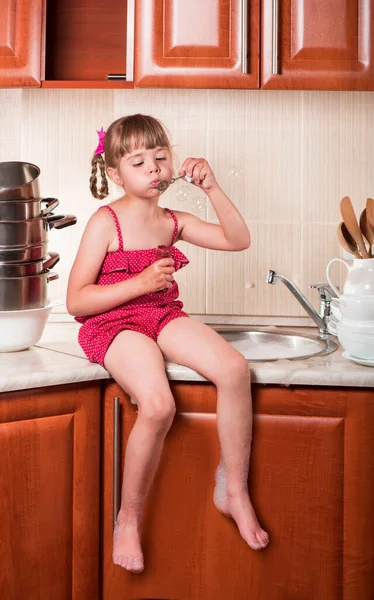 Girl Washes Dishes Blows Soap Bubbles Kitchen — Stock Photo, Image