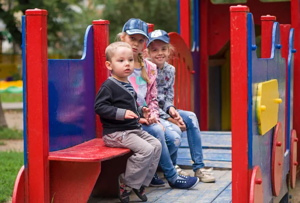 Stock image group of siblings playing together on indoor playground. Cute school kids, girls and boy playing on the colorful playground