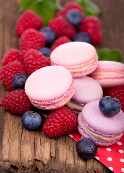Macaroon with raspberries cookies on a wooden background