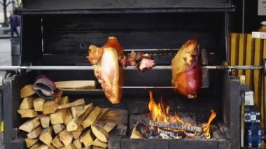Büyük parça et Kızartma domuz eti şiş üzerinde bir açık ateş üzerinde hazırlanan bacak. Sokak gıda Prag, Çek Cumhuriyeti.