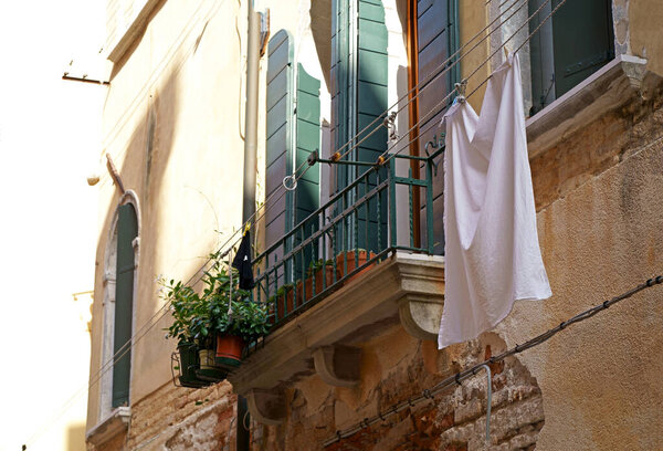Gorgeous Venice. The narrow street channel. Picturesque laundry drying on clothesline