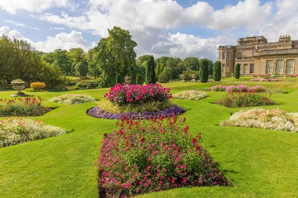 stock image Disley, Stockport, UK - September 7, 2022: The historical formal garden at Lyme Hall with  colourful flower beds and manicured lawns.