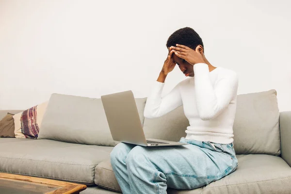 black woman worried with laptop