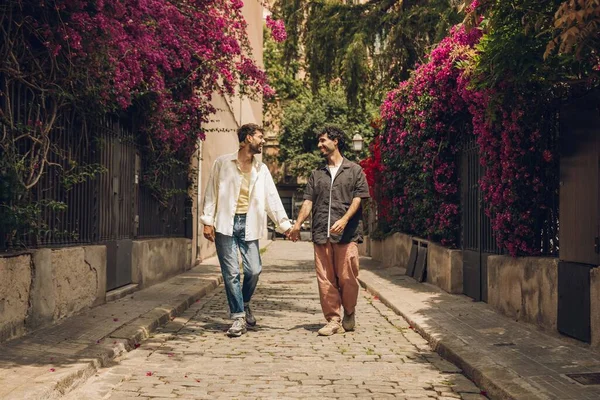 stock image Two young men talking and laughing in the garden. Men having fun together.