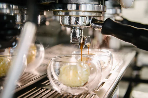 stock image Coffee machine. Coffee with foam is poured from the holder into glass cups. Ice cream scoops in glasses. Steam is coming