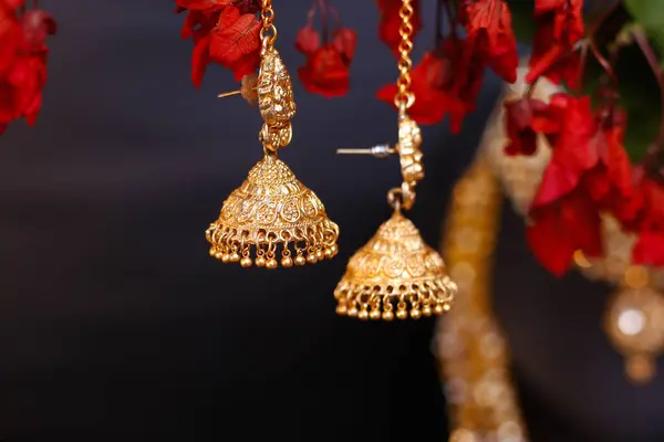 Fancy Designer golden earrings jewelry with newest fashion. Clicked on Nature Flower background