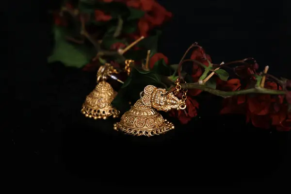 Süslü Tasarımcı altın küpeler yeni moda mücevherler. Doğa Çiçeği arkaplanına tıklandı. Kapatın.