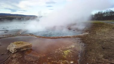 İzlanda 'nın en ünlü sıcak su gayzeri kaynıyor ve püskürmeyi bekliyor. Geysir 60 metreye kadar kaynar su fırlatabilir. Yavaş çekim videosu