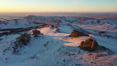 Kazakhstan. Winter mountains, drone flight at sunset 4K.