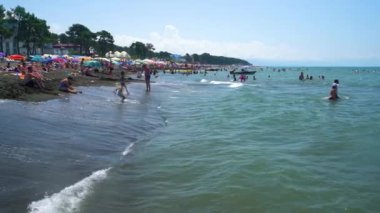 People relax on the waves of the magnetic beach.Georgia. August 10, 2022.