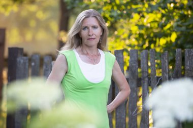 Portrait of a beautiful elderly blonde woman outdoors.