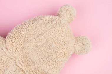 Funny bear made of fur on a pink background. Abstract bear.