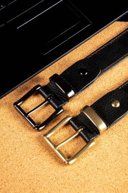Part of leather belts with metal buckles.