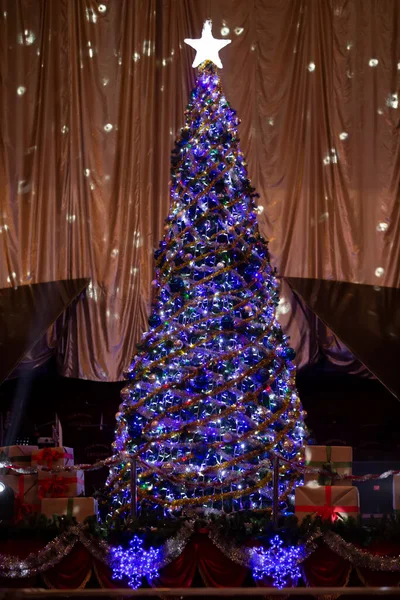 Vintage Christmas tree in purple lights on a beige background.