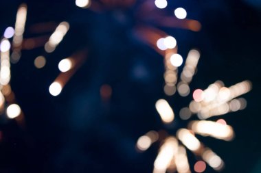 On a black background bokeh from explosions of colorful fireworks.