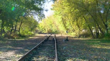 A fork in the railroad tracks in two directions. Close-up of a railroad track. The concept of industrial logistics and transport