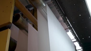 An industrial machine makes wallpaper.