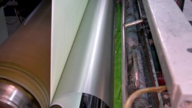 An industrial machine makes wallpaper.