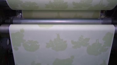 An industrial machine makes wallpaper.