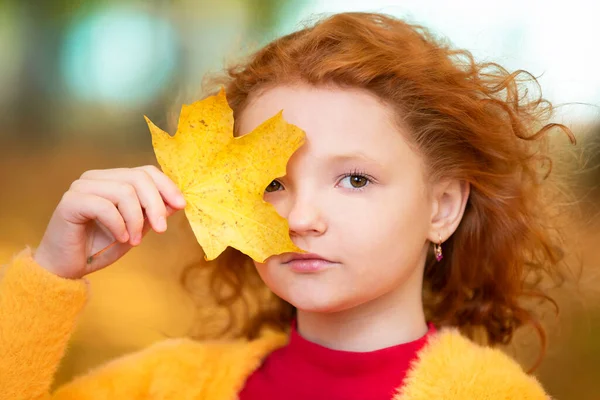 Red Haired Little Girl Closes One Eye Yellow Maple Leaf — Stock Photo, Image
