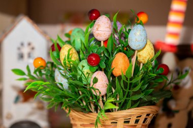 Yeşil çimenler ve el yapımı dekoratif yumurtalarla dolu Paskalya sepeti..