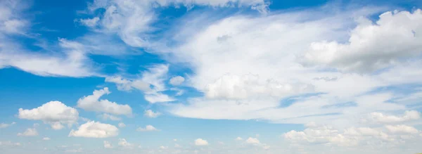 Banner of white clouds on a blue sky background.