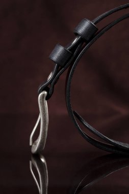 Black leather belt on a dark background. Leather products.