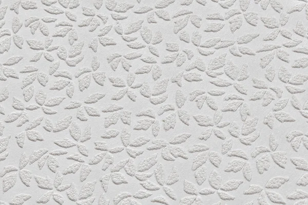 抽象的な花の繰り返しパターンを持つ白い紙の壁紙のテクスチャを閉じます プラスチック製エンボス加工の壁 — ストック写真