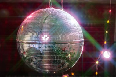 Disco ball with bright beams, night party background photo. clipart