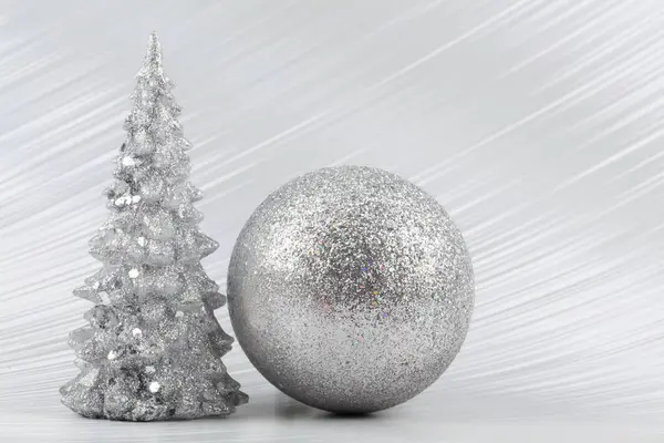 stock image Christmas or New Year background with silver snowy tree and silver transitional decoration. Bright festive background.