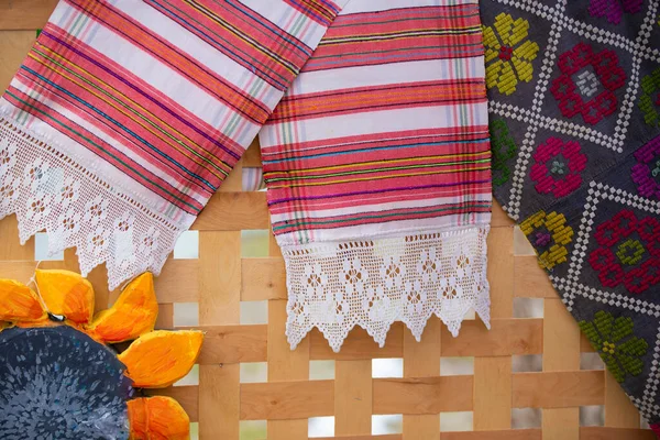 Ethnic Slavic embroidered towels Belarusian or Ukrainian on a wooden background.