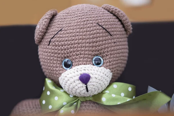 Funny handmade knitted bear close-up.