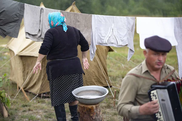 Belarus, Gomel bölgesi, 20 Temmuz 2022. Mülteci kampı. Mülteci bir kadın dışarıda kurutmak için kıyafet asıyor..