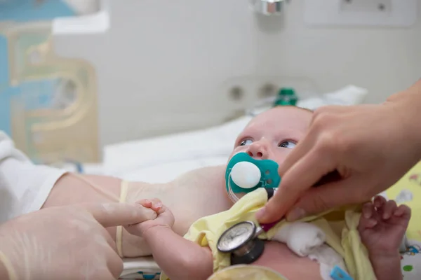 May 31, 2021. Belarus, Gomil. Neonatal Intensive Care Unit. The doctor listens to the heart of a newborn baby.