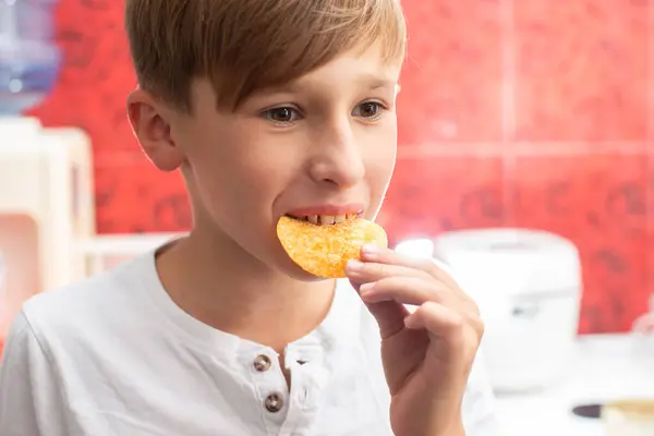 Boy eating chips close-up. Potato chip child.
