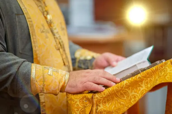 stock image The hands of an Orthodox priest hold a bible