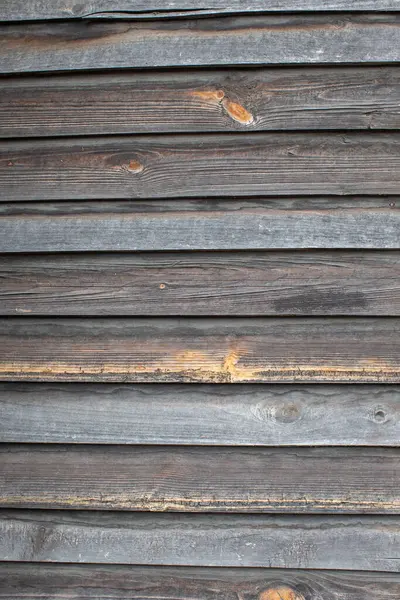 Classic background of wooden planks of uneven gray color.