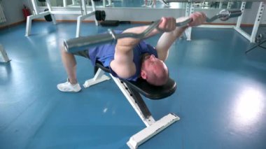 Atletik yapılı bir adam halter kaldırır. O yalan söylüyor..
