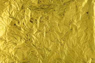 Buruşmuş altın folyo kağıdı dokusu.