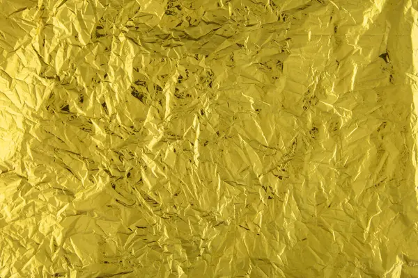 Buruşmuş altın folyo kağıdı dokusu.
